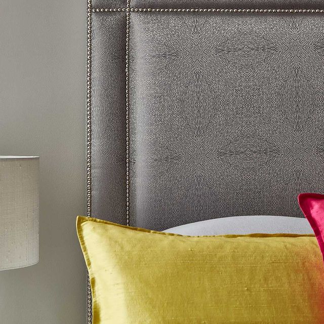 A lamp and pillows for a bedroom